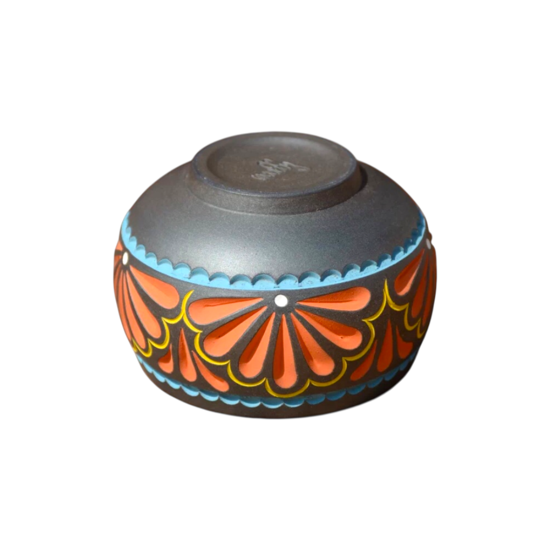 Handmade colored carvings of tea cups using slow wheel Dei pottery techniques